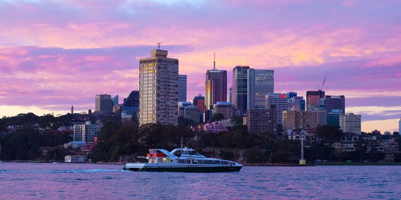 Boat on river with Sydney business district skyline in background