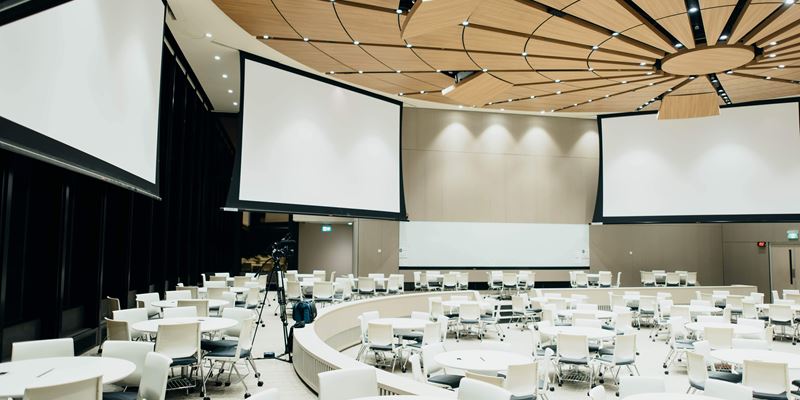 Hybrid Event space in big conference hall with white setting