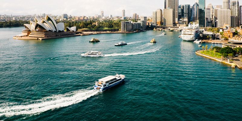 Boats in Sydney harbour with business district in background